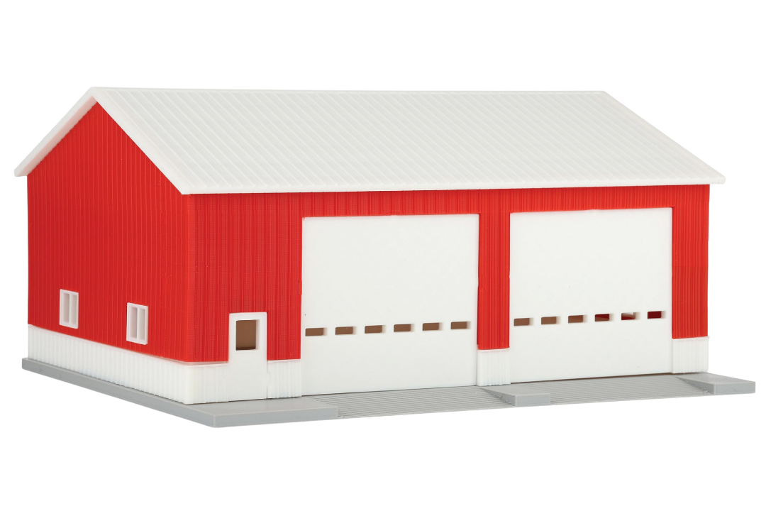 Model of a red and white barn on a white background